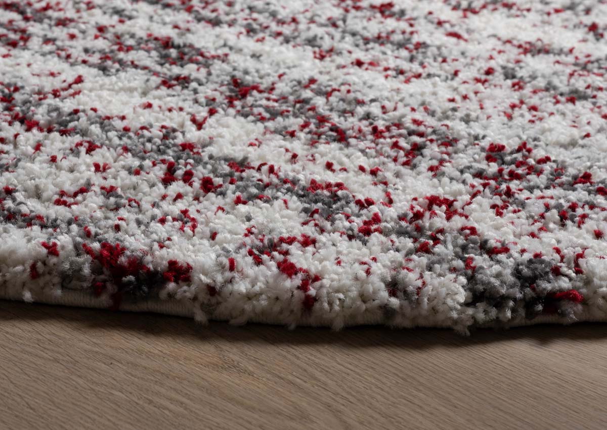 Alfombra redonda de pelo largo con topos Artisan - Gris/Rojo - close up zijkant Alfombra redonda de pelo largo con topos Artisan - Gris/Rojo - close up zijkant