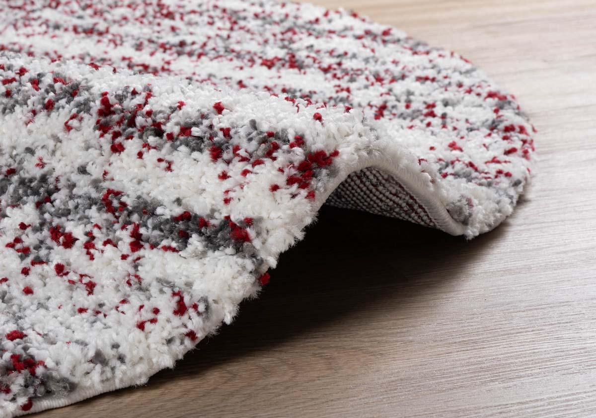 Alfombra redonda de pelo largo con topos Artisan - Gris/Rojo - close up zijkant Alfombra redonda de pelo largo con topos Artisan - Gris/Rojo - close up zijkant